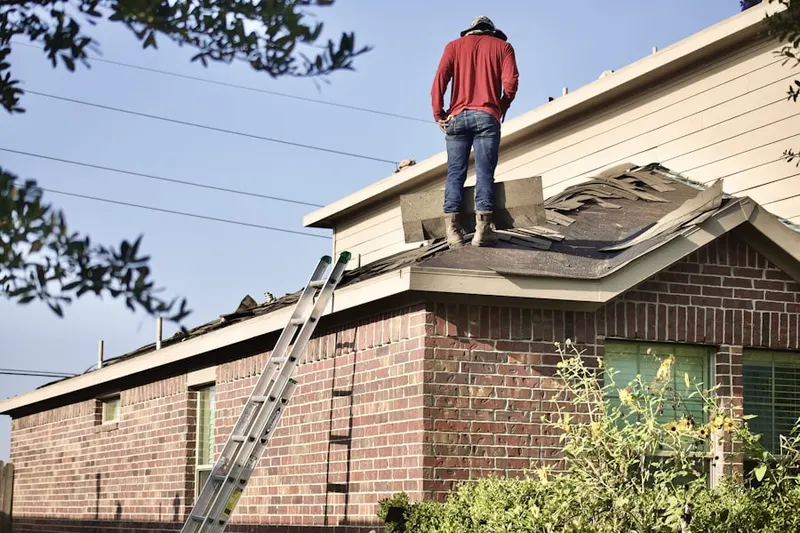 Professional roofer working on a residential roof in Denair